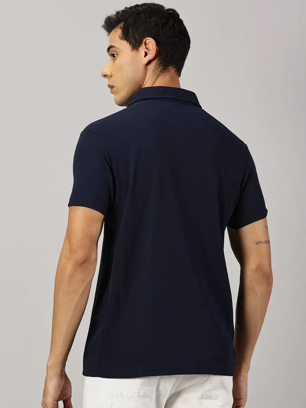 A model wearing Blue Tyga navy blue odor-free polo t-shirt