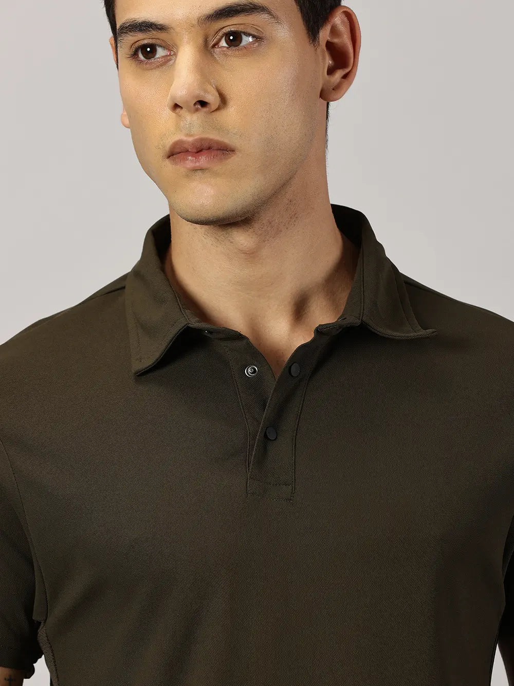 A model wearing Blue Tyga olive odor-free polo t-shirt