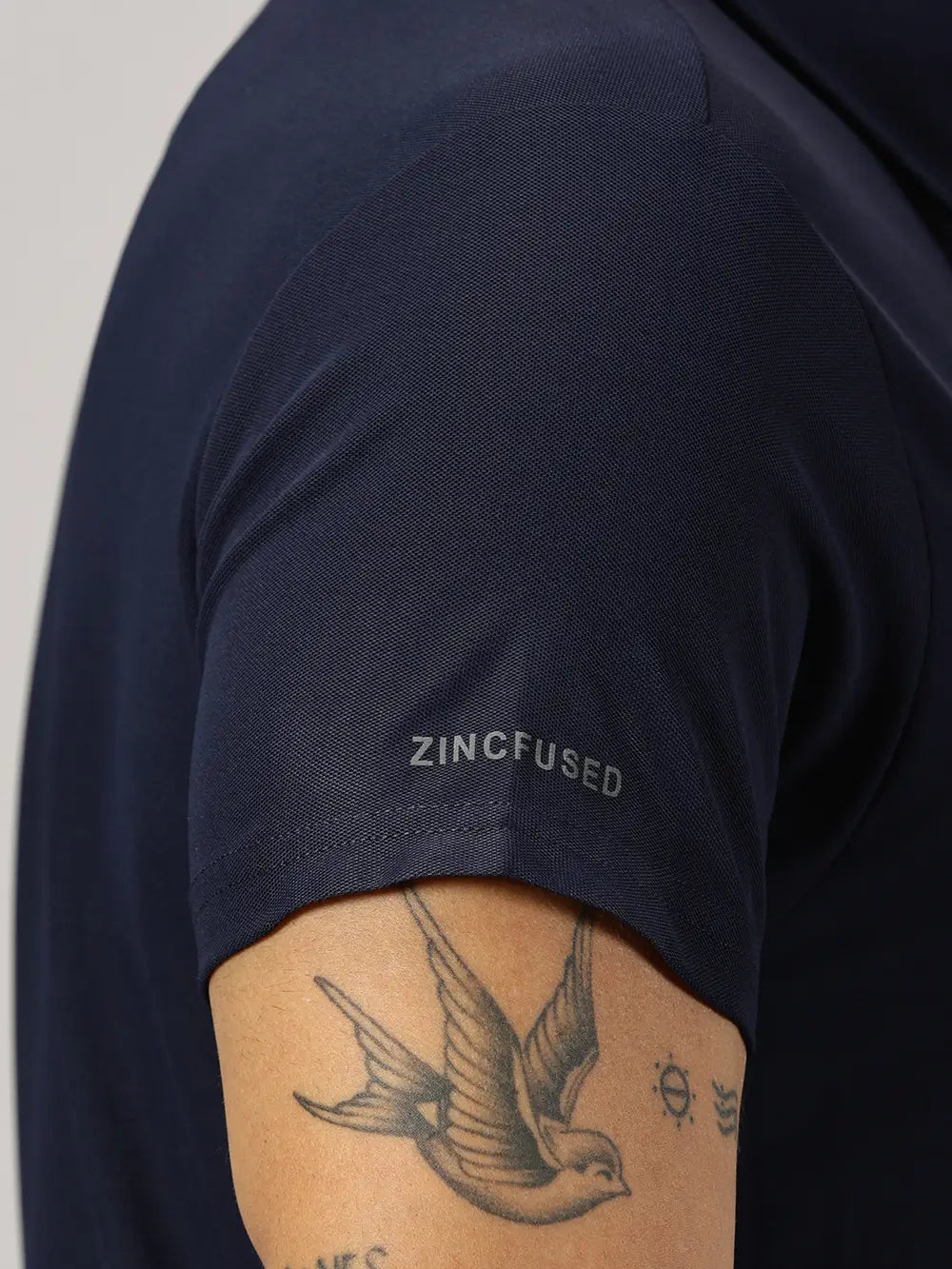 A model wearing Blue Tyga navy blue odor-free polo t-shirt
