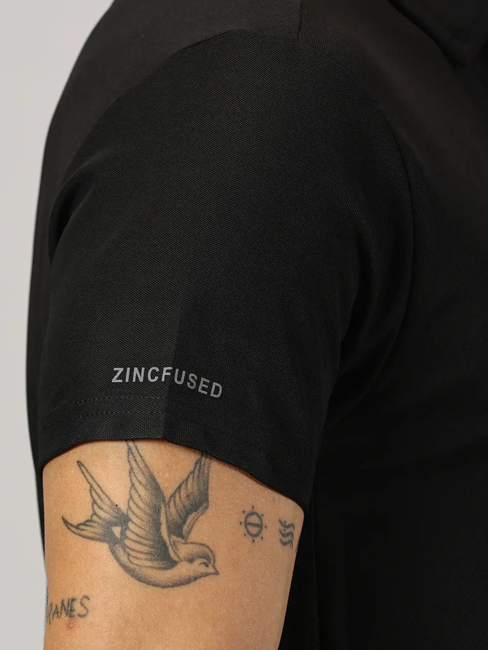 A model wearing Blue Tyga black odor-free polo t-shirt